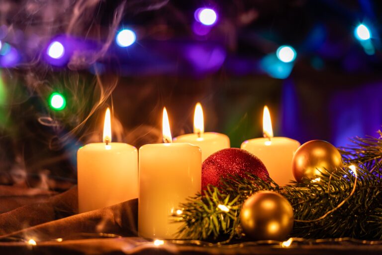 Christmas candles on table with ornaments