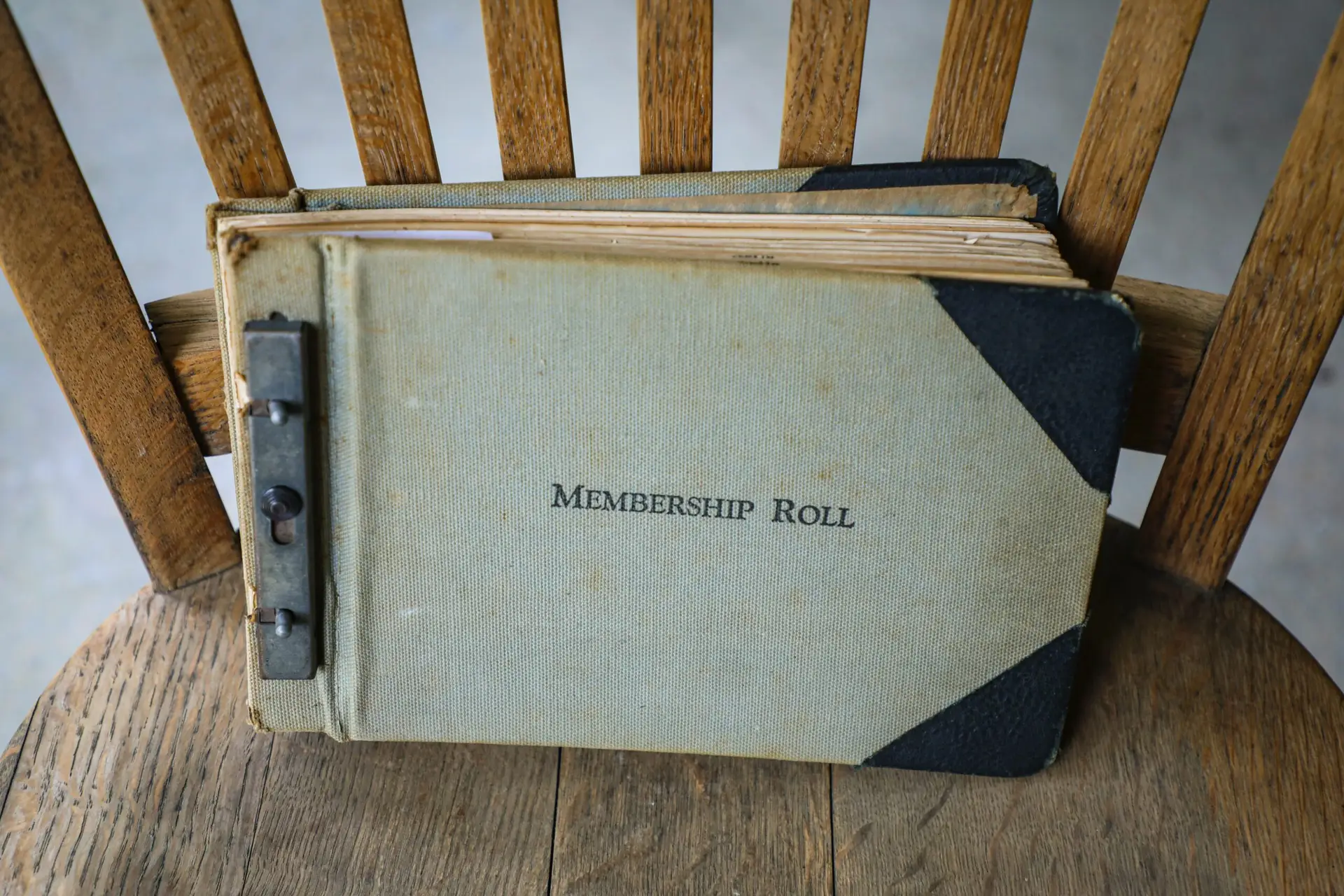 Membership roll book in wooden chair