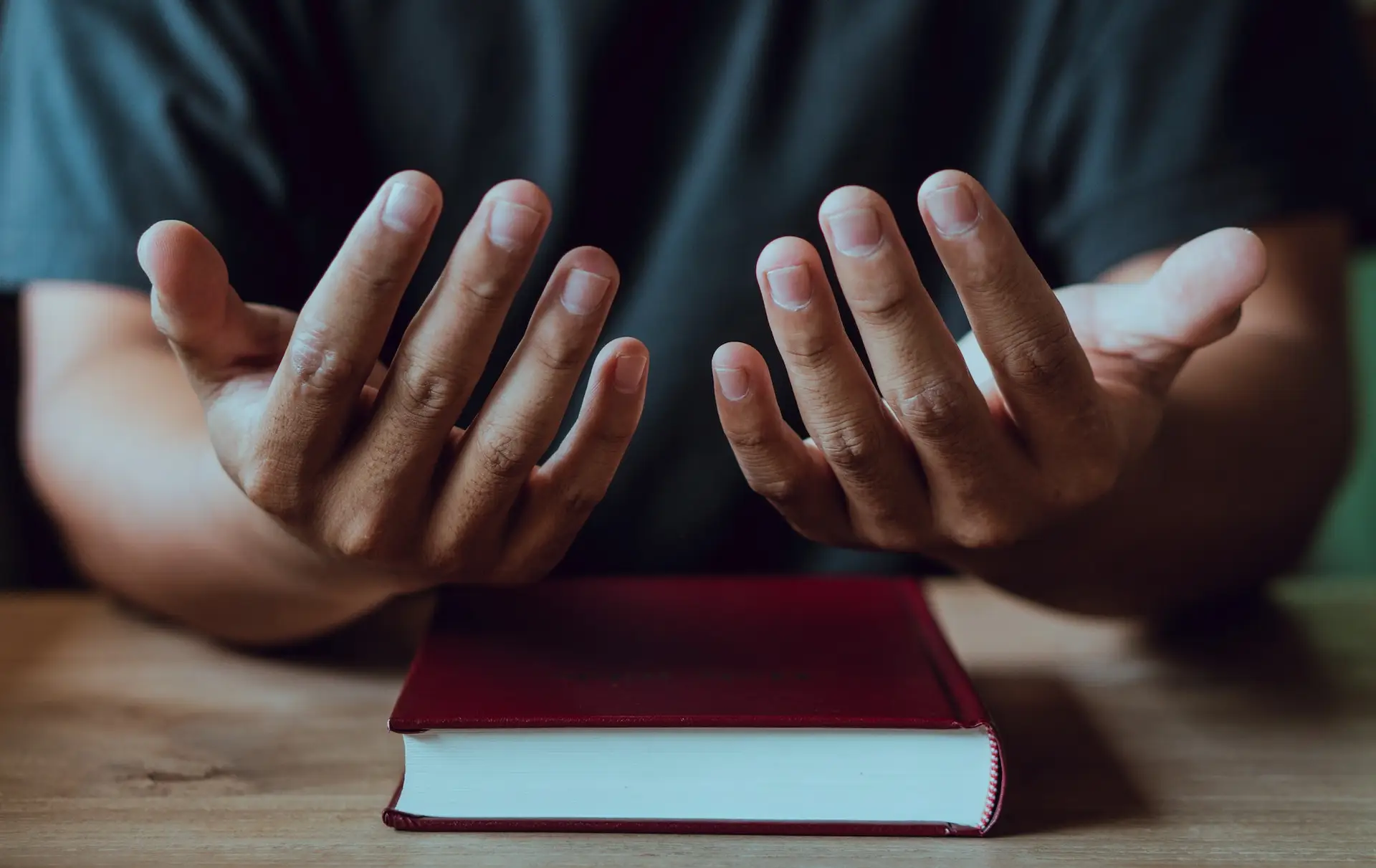 Hands of man with Bible praying.Christian life prayer to god. Man Pray for god.believe in goodness.