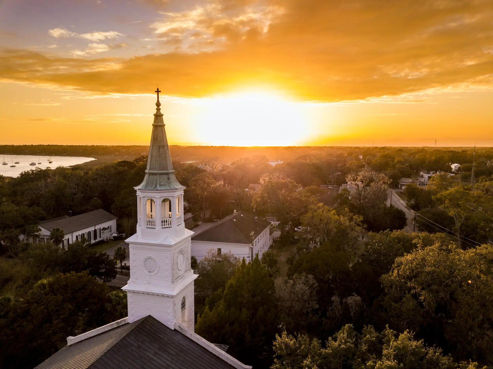 Aerial view of historic church steeple and sunset in Beaufort, SC neighborhood