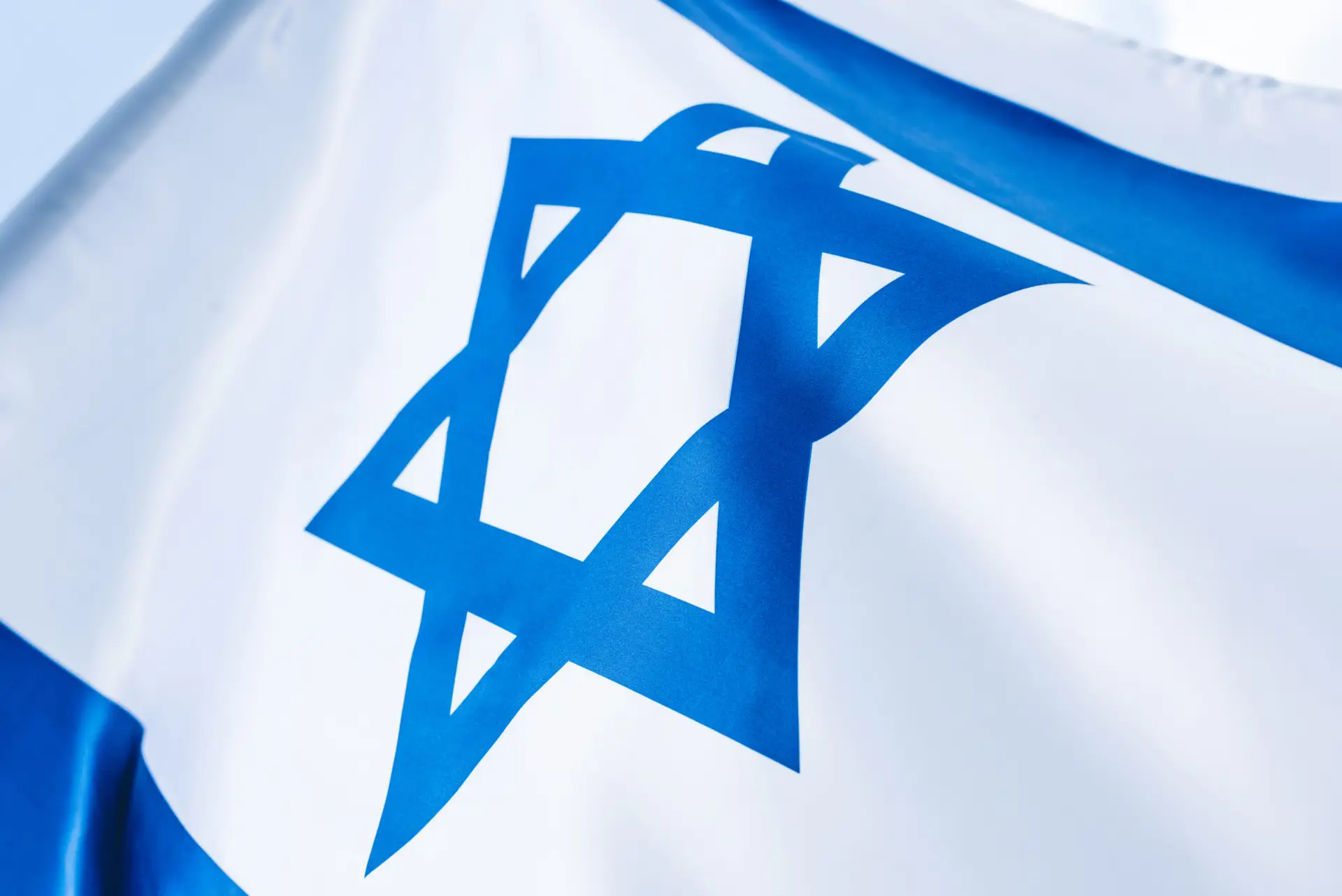 Close up of blue star of David on national flag of Israel