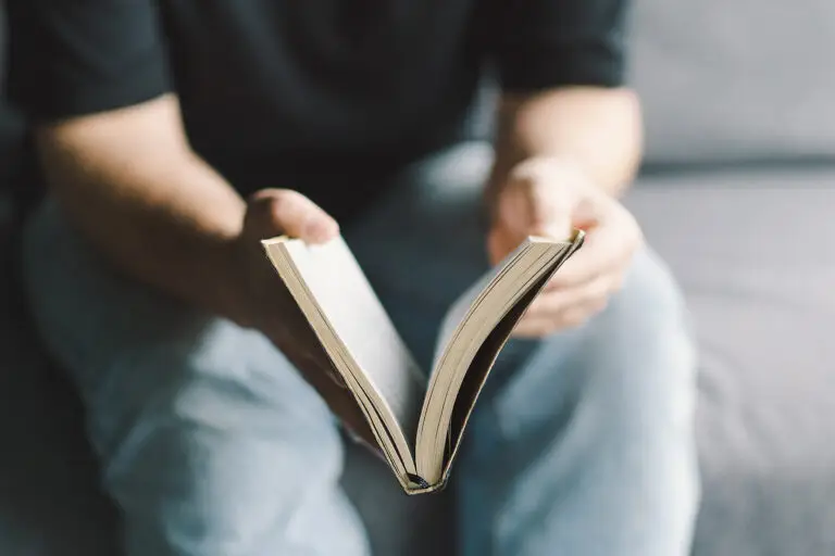 Christian man holds holy bible in hands