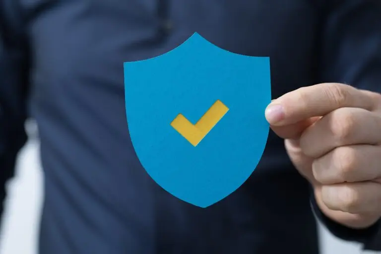 A man holding a protection shield with a checkmark