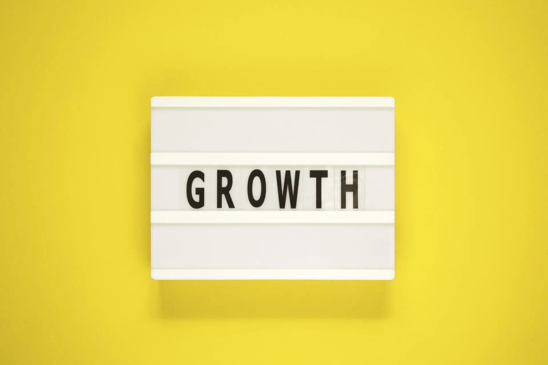 The word growth on light box with yellow background