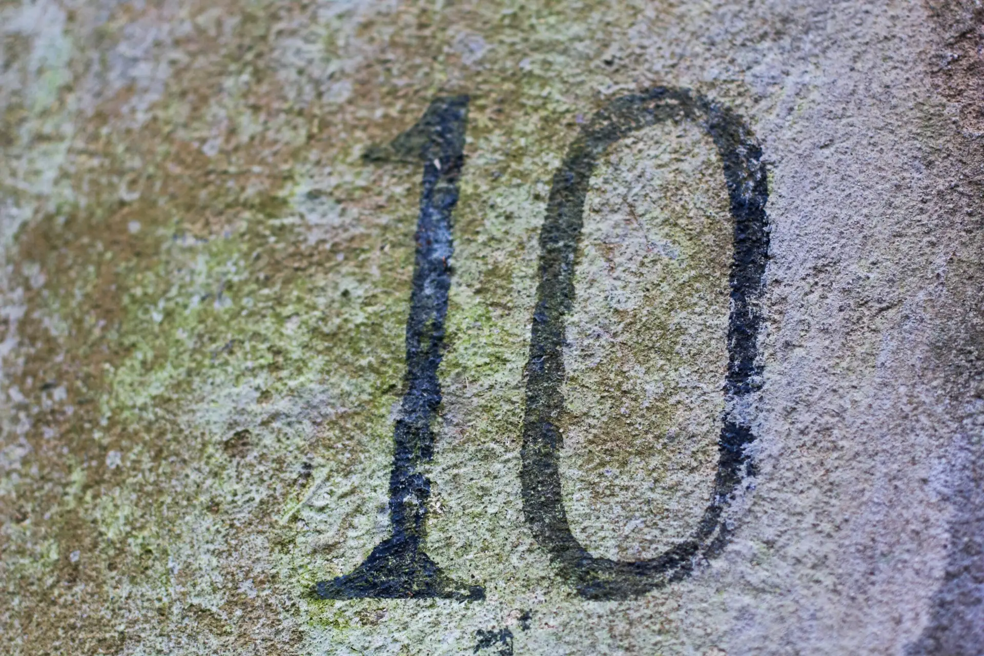 Close up of a number 10 on a rock